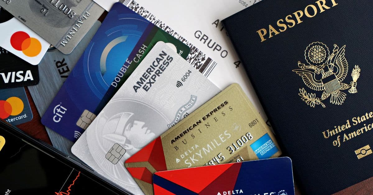A collection of travel essentials including a passport, credit cards, and a boarding pass. Ideal for travel and finance concepts.