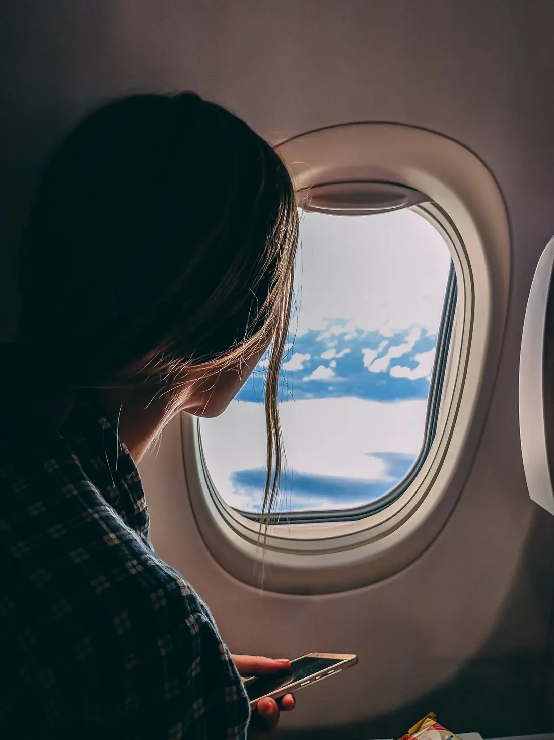 Traveller seated beside an aircraft window