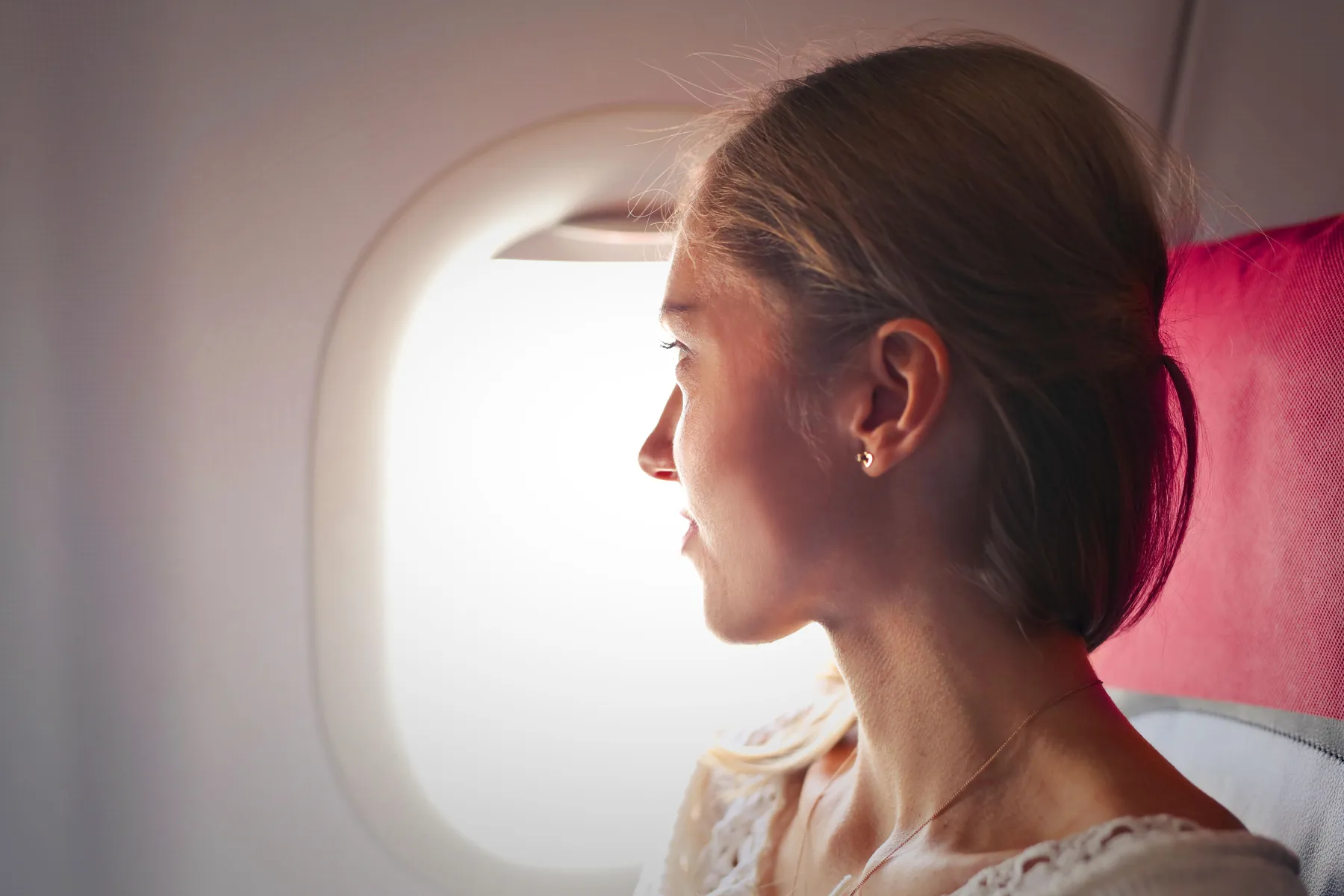 Traveller looking through an aircraft window